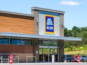 The entrance and exterior of an Aldi grocery store showing signage and parking area