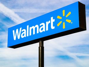 Walmart logo on a pole against the sky