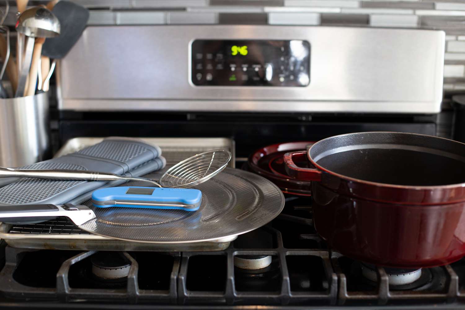 Supplies for Frying Brussel Sprouts: A Dutch Oven, Splatter Screen, Thermometer, Spider Strainer, and Oven Mitts