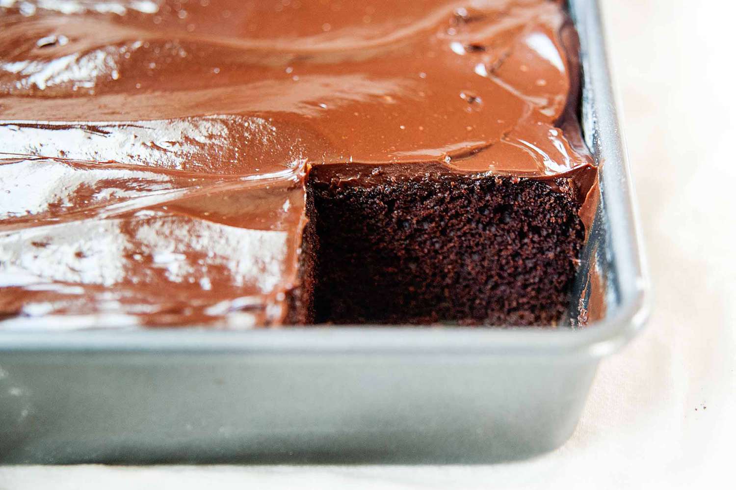Sour cream chocolate cake with frosting in a pan