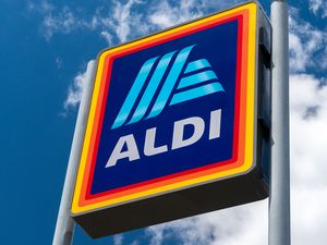 ALDI sign against a blue sky