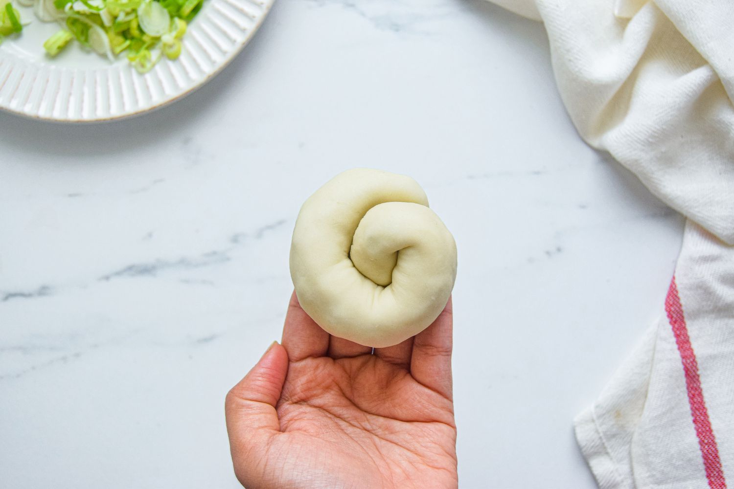 Shaping the scallion pancake dough into a spiral.