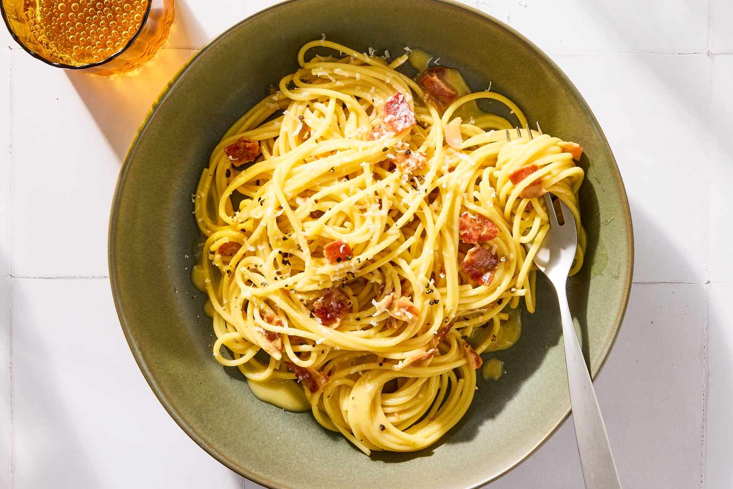 Plate of pasta carbonara with a fork on the side