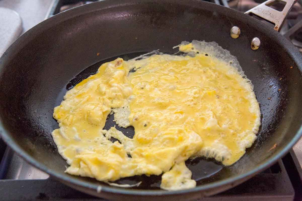 Beaten eggs cooking on a pan