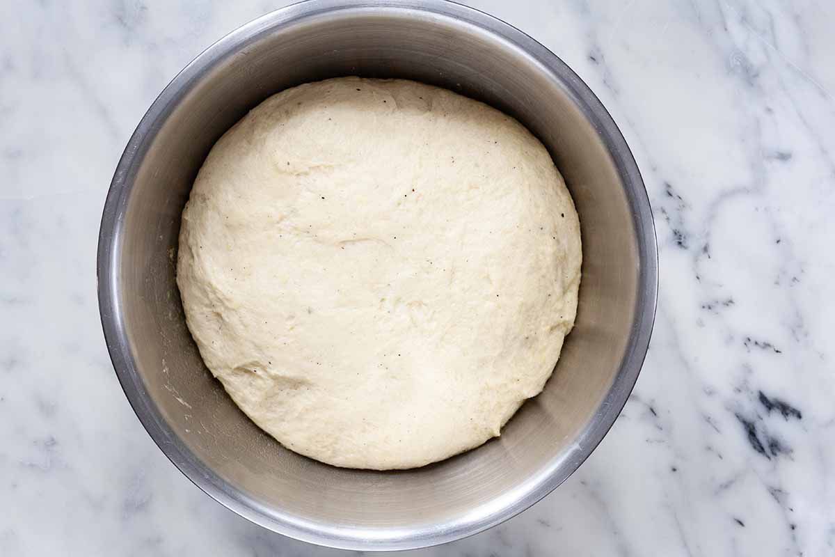 Risen Dough for Stollen in a silver mixing bowl