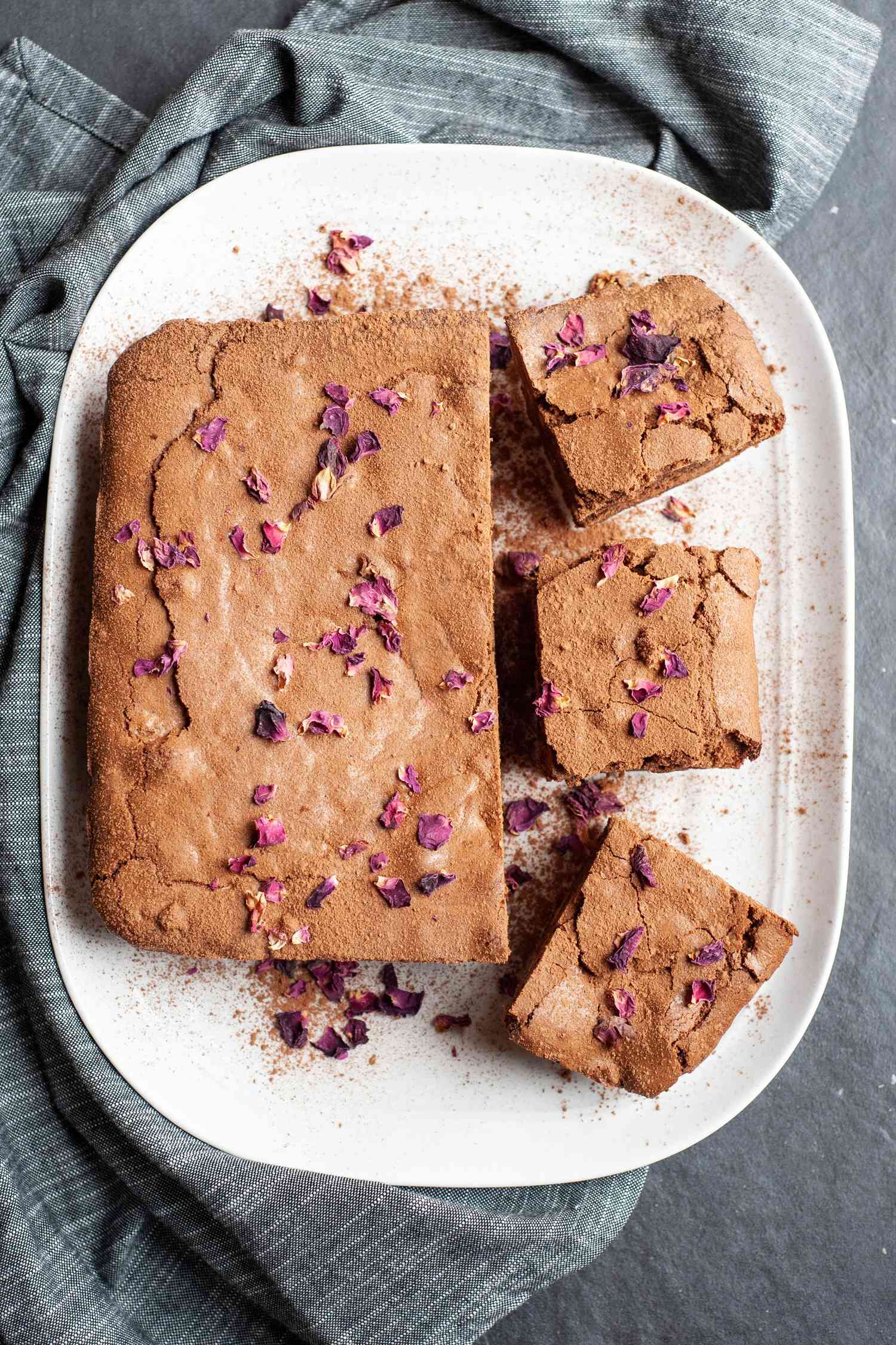 Spiced brownies on a white platter.