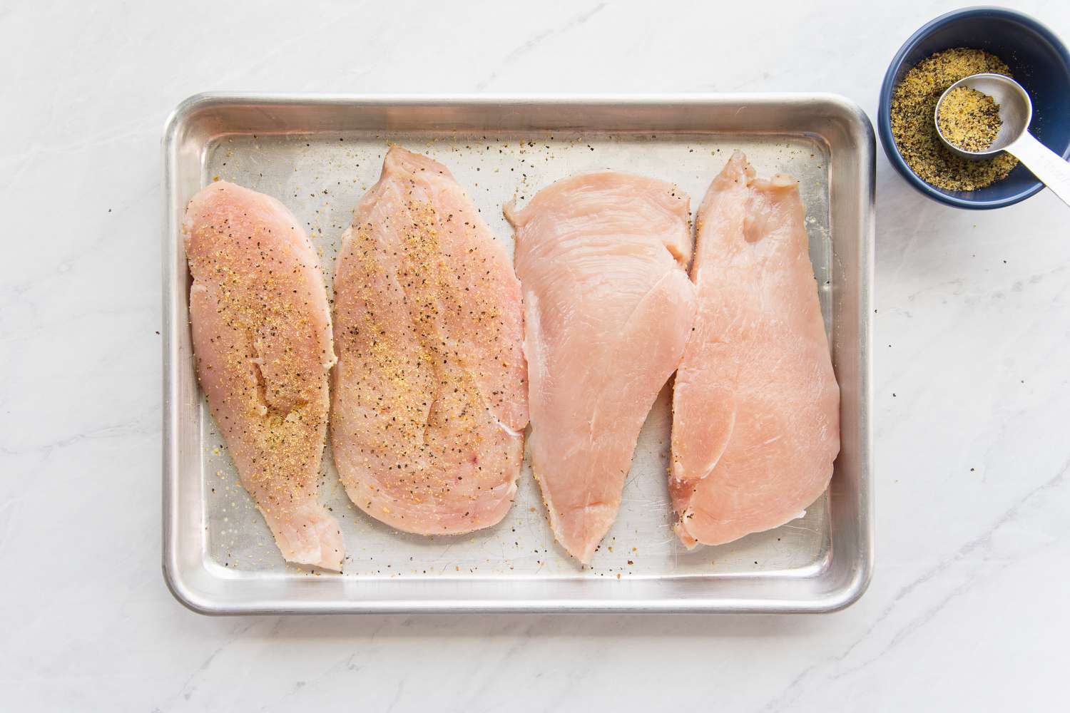 Cutlets Seasoned with Lemon Pepper on a Baking Tray