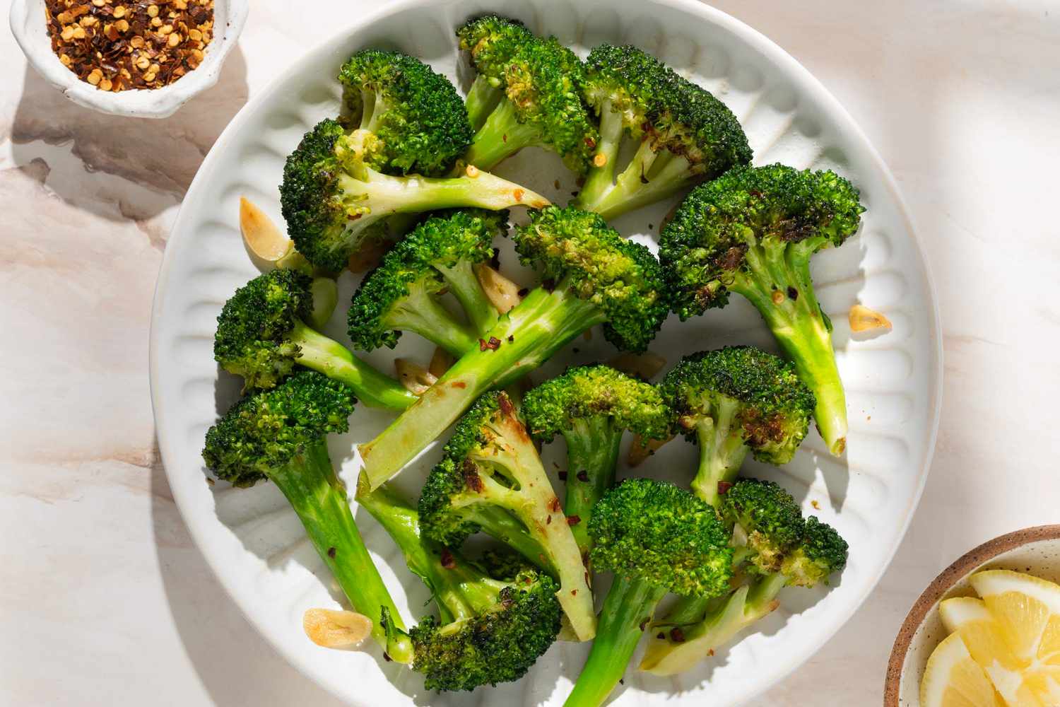 overhead view of 10-Minute Broccoli (Garlic Broccoli) with chili oil on the side