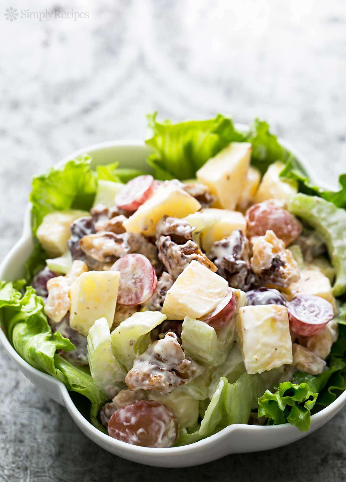 A Waldorf Salad in a scalloped white bowl
