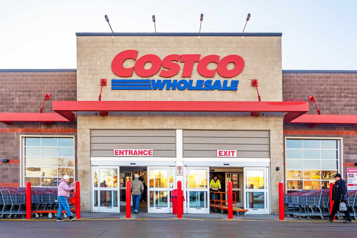 The front entrance of a Costco Wholesale store, with people walking in and out