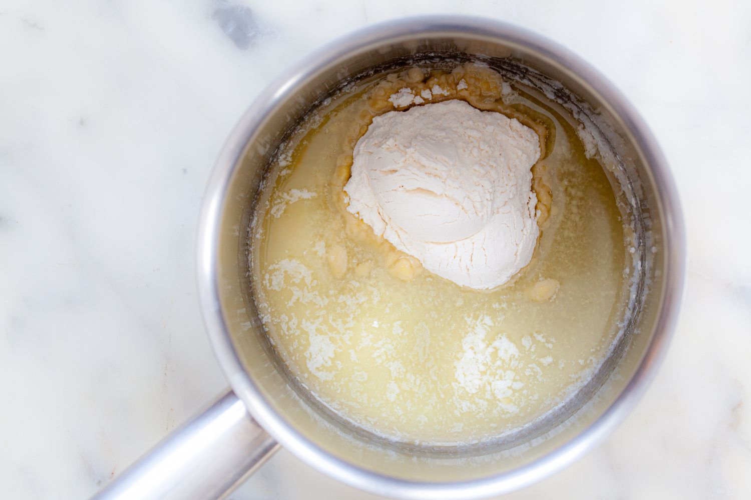 Ingredients in a saucepan to show how to make béchamel sauce