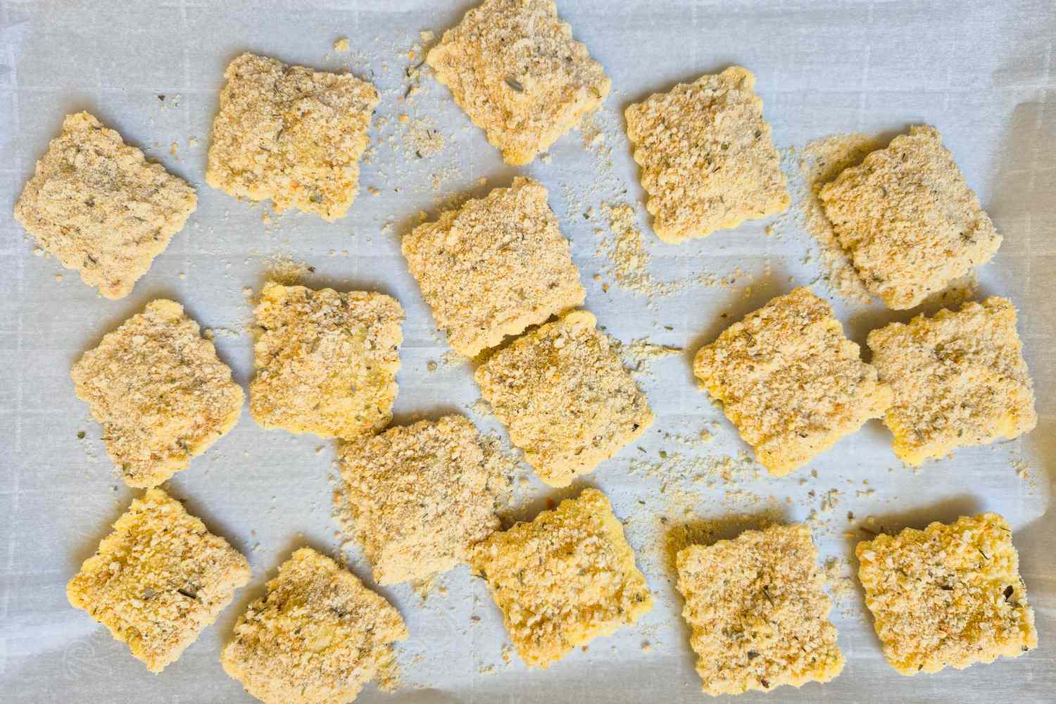 Crispy ravioli arranged on a baking sheet