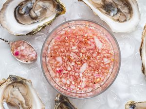Overhead view of oyster sauce surrounded by oysters.