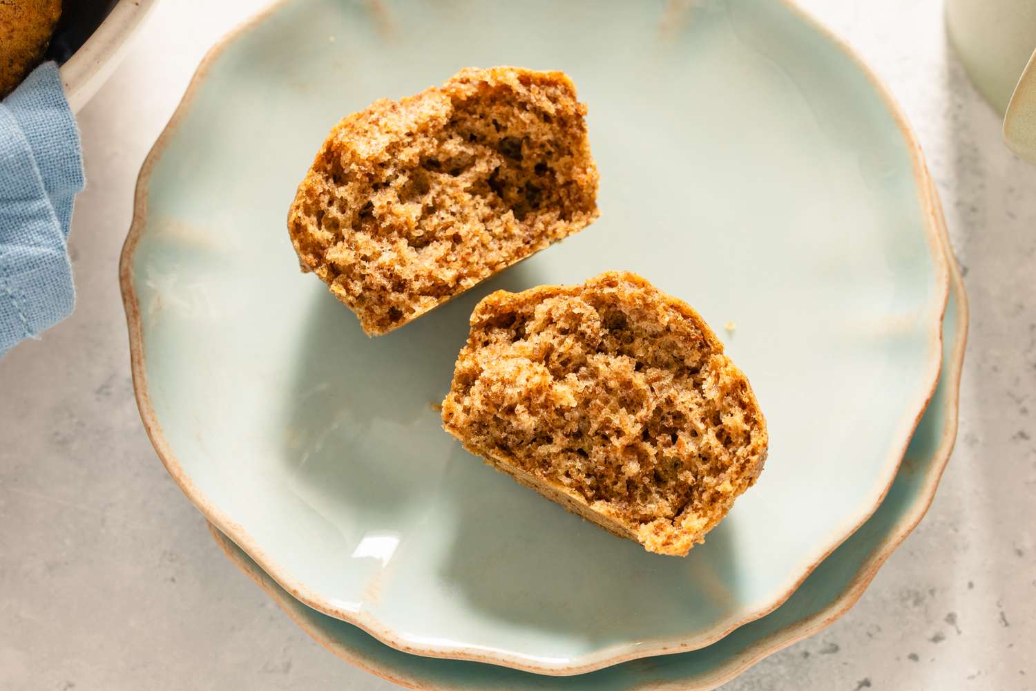 A Six-Week Refrigerator Muffin split in half on a light blue plate