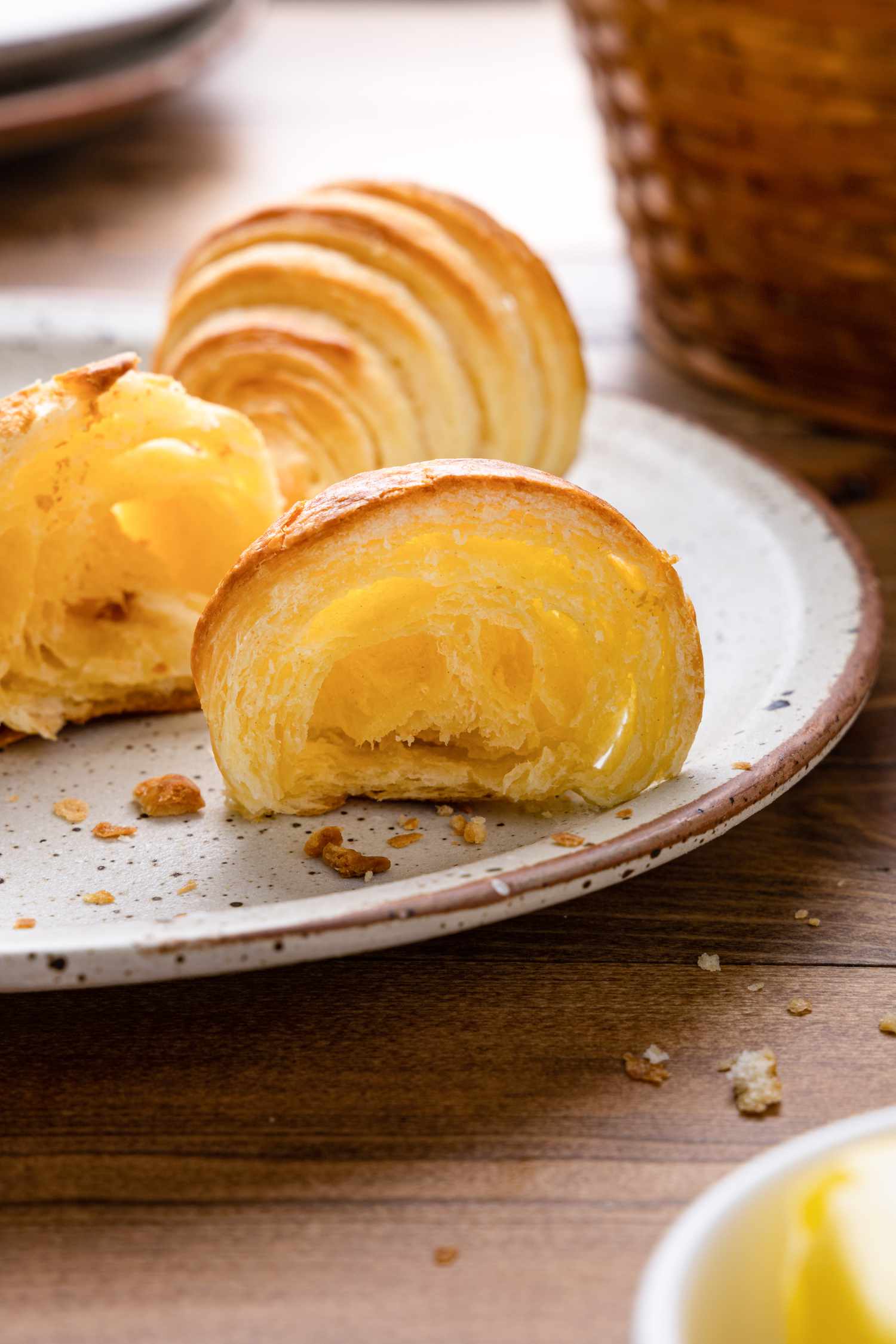 Homemade Crescent Roll on a Plate Cut in Half Showing Cross Section Lamination