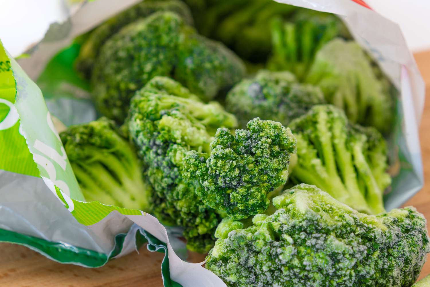 Frozen broccoli spilling out of a bag