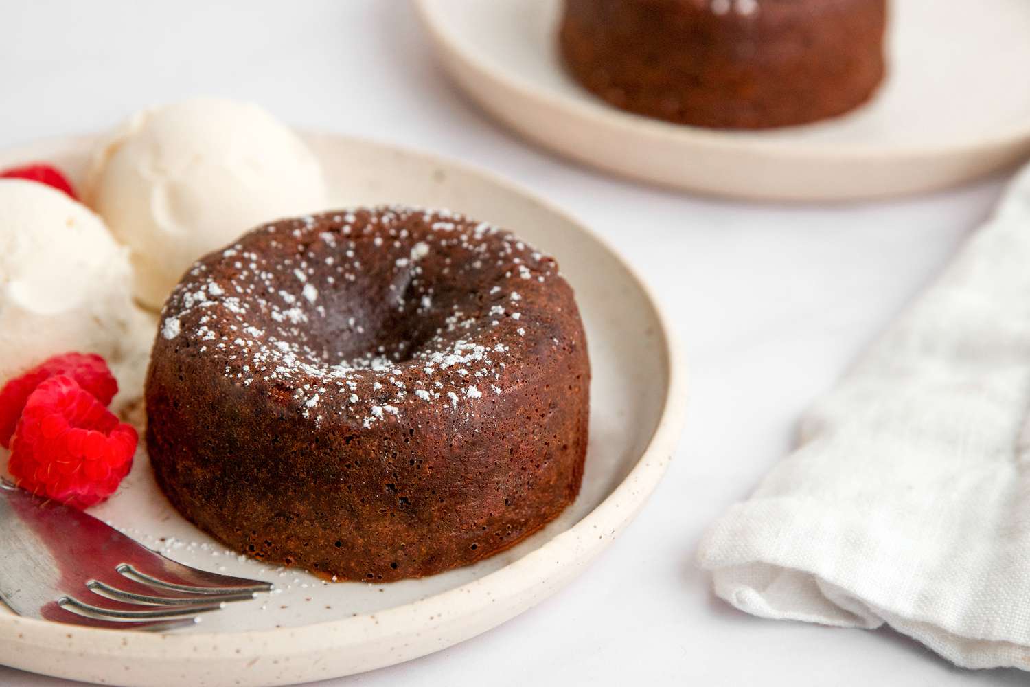 Chocolate lava cake with scoops of ice cream.