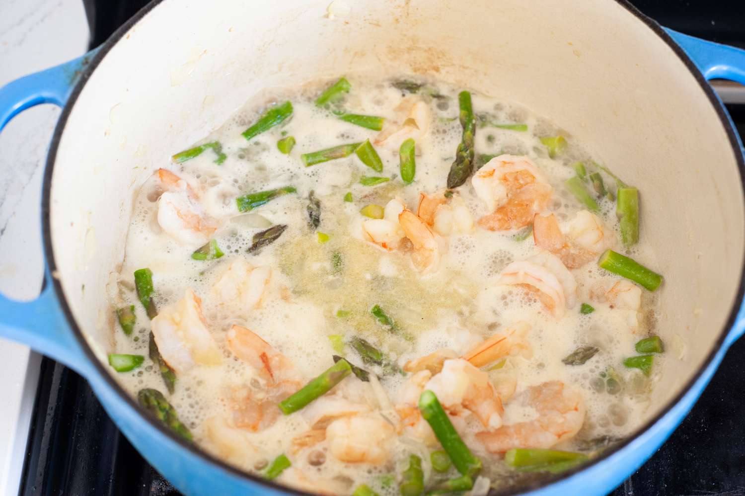 Reduce White Wine in Dutch Oven for Shrimp and Asparagus Pasta