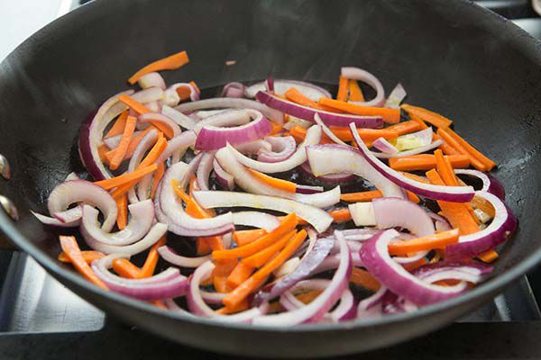 carrots and onion in skillet for pasta primavera