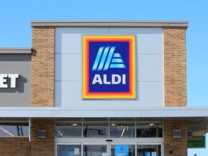 The front facade of an Aldi store with its sign prominently displayed and part of the entrance visible