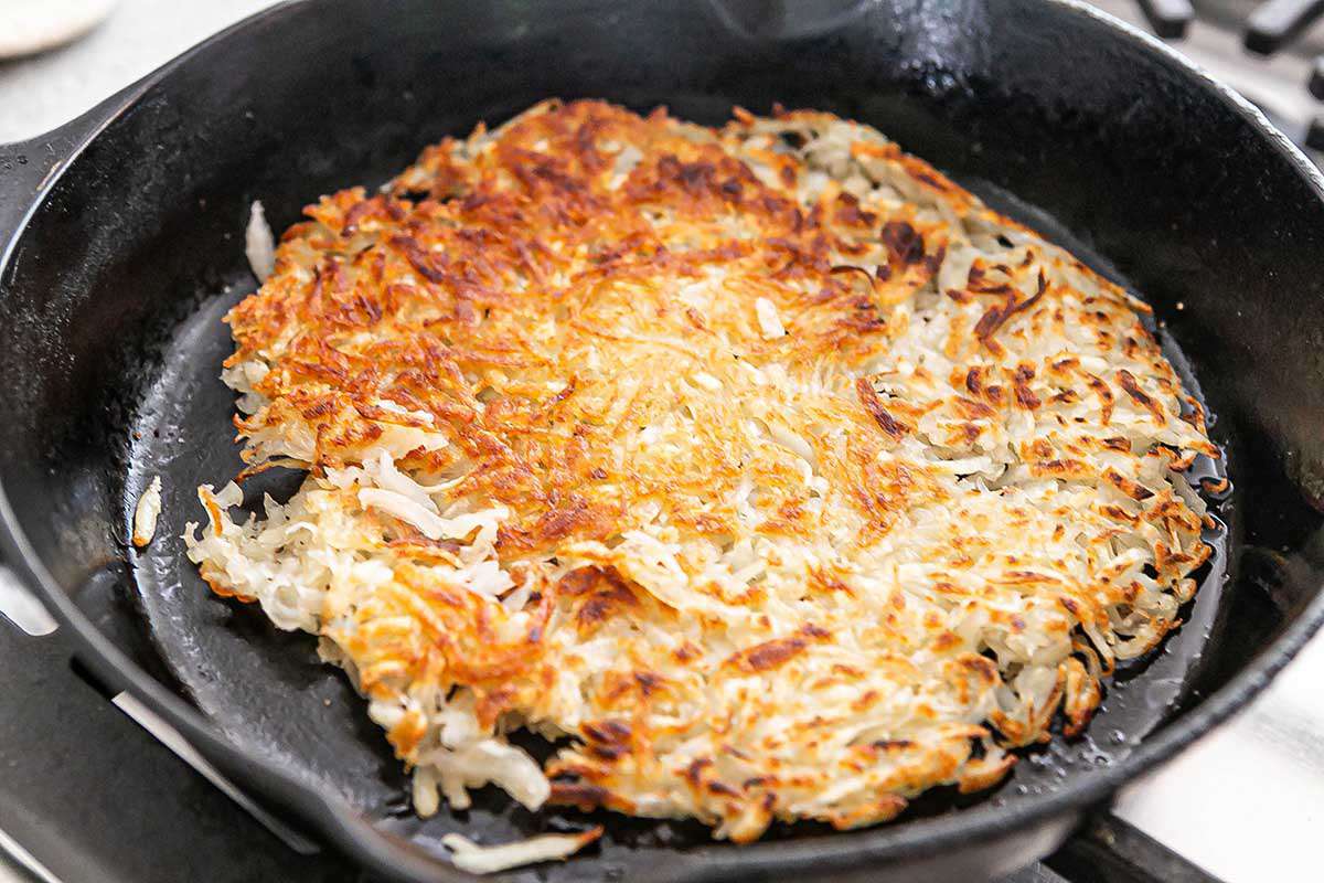 Hash browns cooking on a skillet