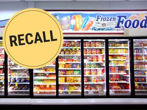 Freezer section in a store with a recall notice sign placed in the image
