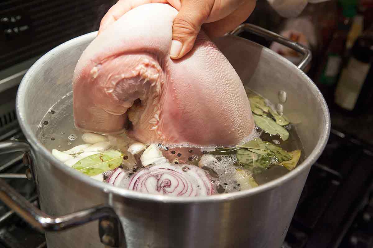 first slow cook beef tongue in water with aromatics for tacos de lengua