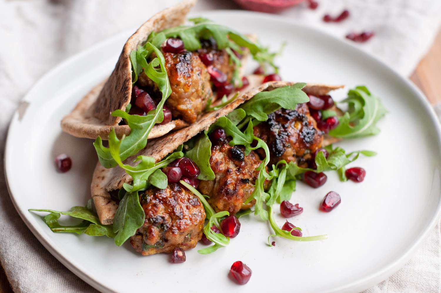 Plated lamb meatball pitas with watercress and mint 