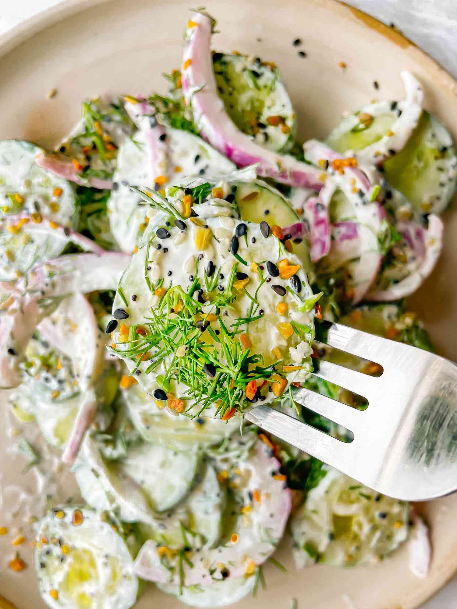 Everything Bagel Cucumber Salad with a Piece on a Fork