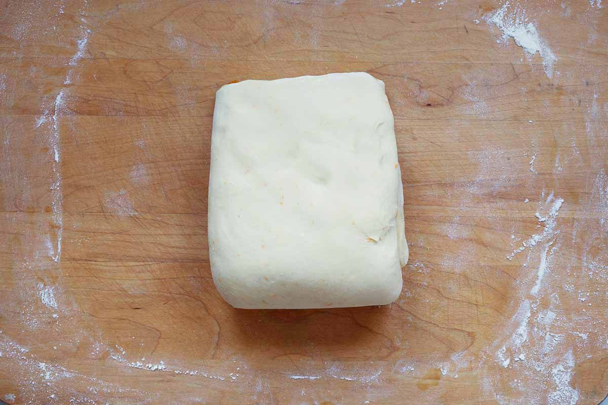 Small square of panettone dough on a cutting board