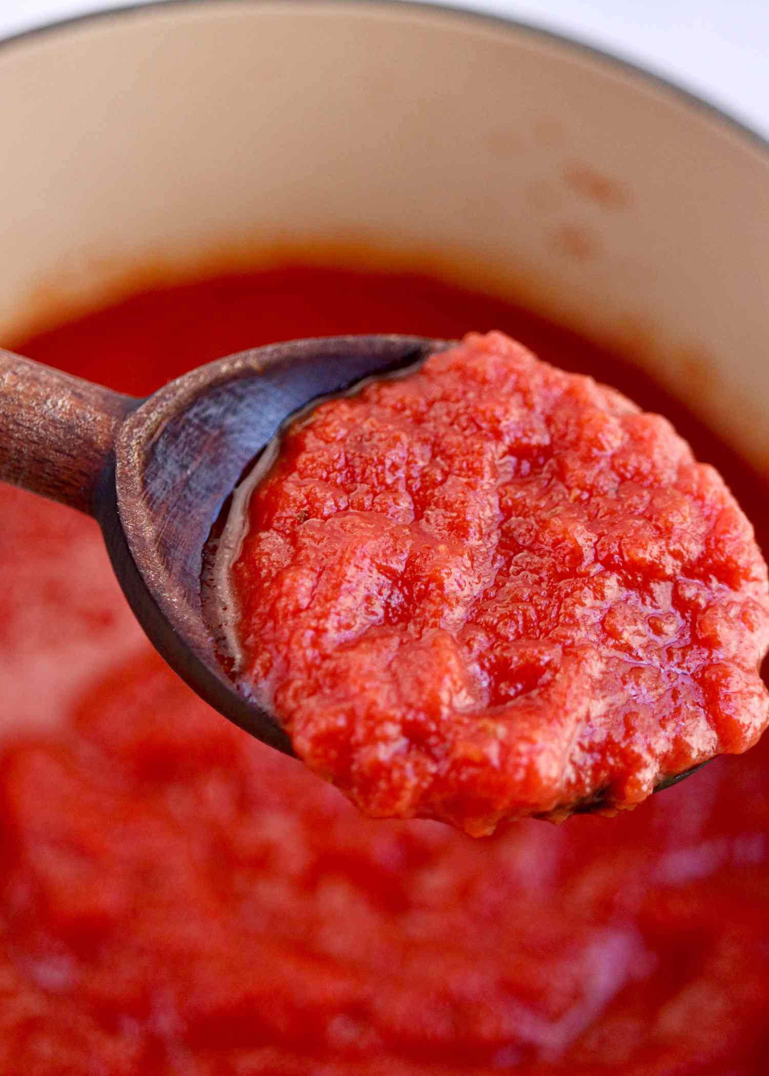 Homemade Pizza Sauce on a wooden spoon.