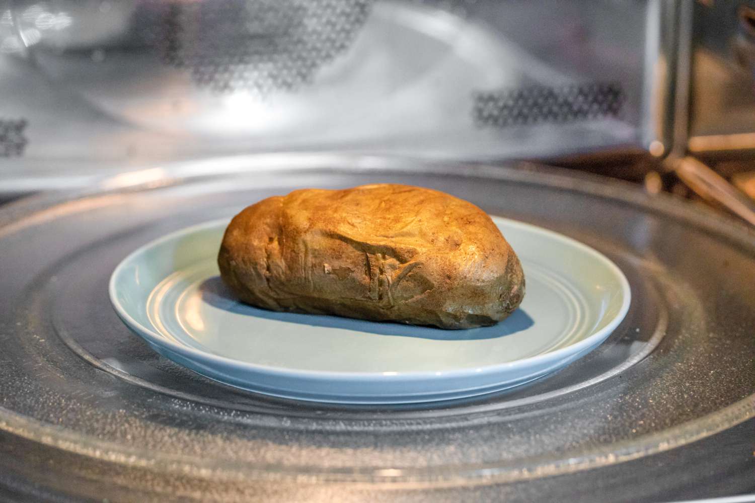 Microwave Baked Potato on a Plate in the Microwave