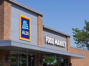 Exterior of an Aldi Food Market store entrance with a visible sign displaying the stores name