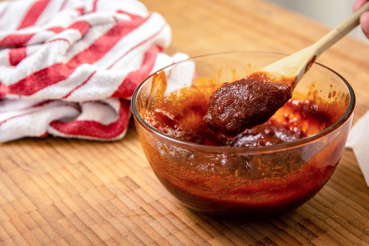 Spoonful of Microwaved BBQ Sauce Lifted from Bowl for Microwave Chicken Wings Recipe
