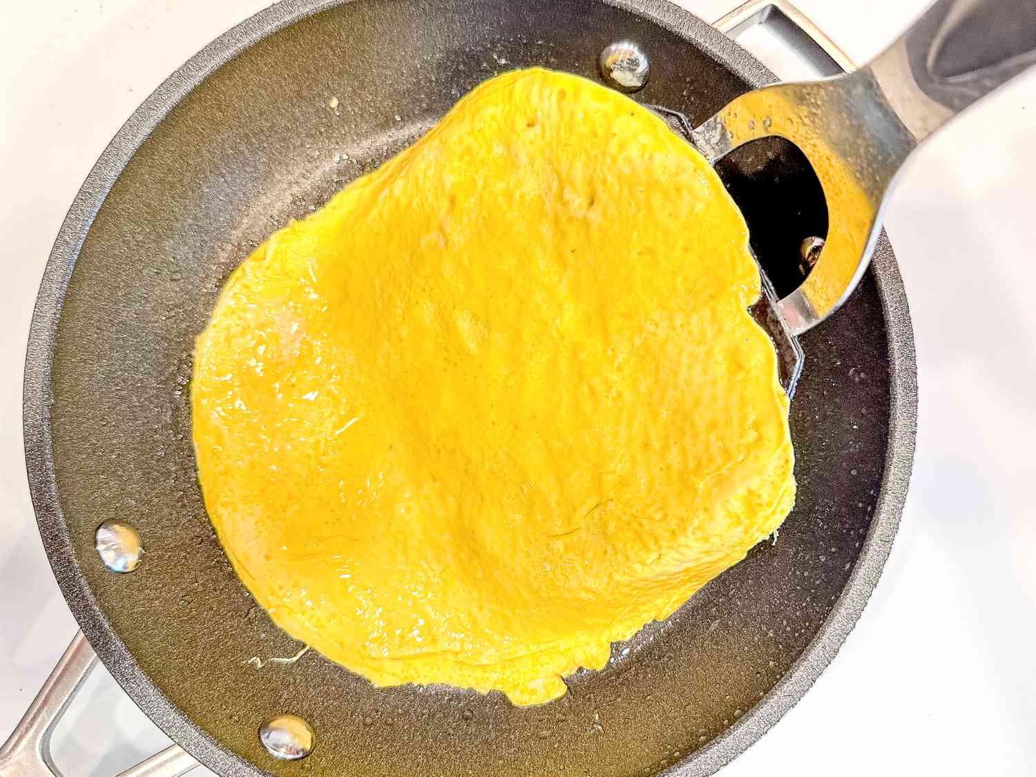 thinly cooked eggs liftec from a pan for japchae recipe