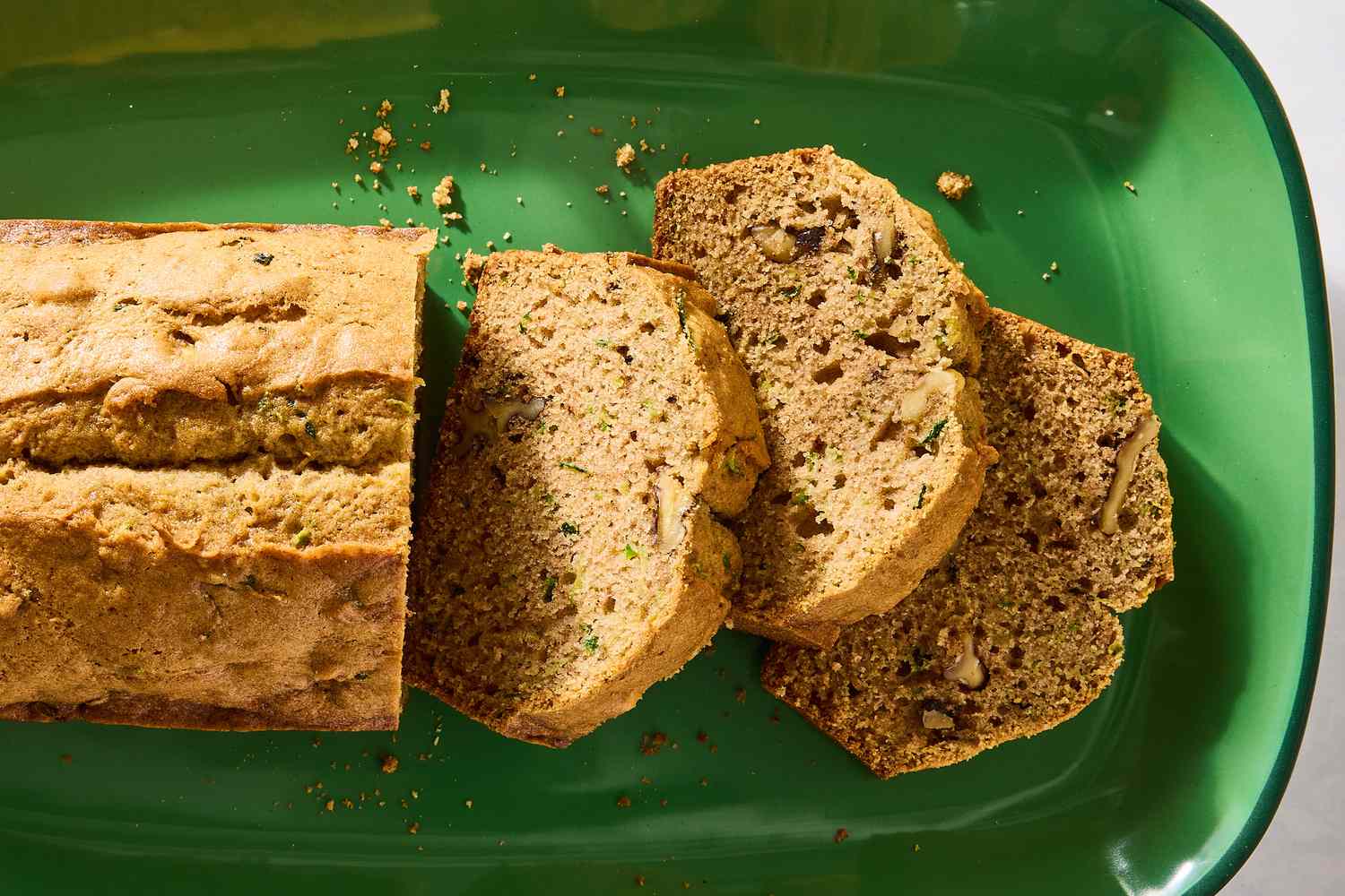 Slices of zucchini bread on a green plate