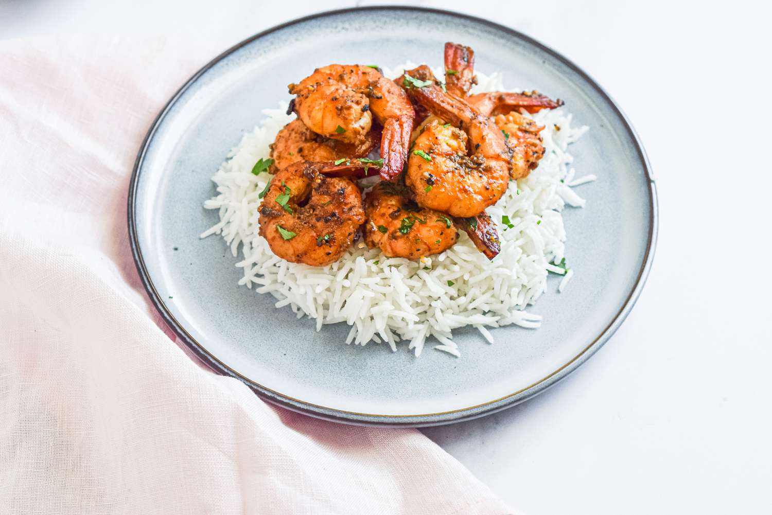 Peppery Garlic Shrimp Over Rice on a Plate