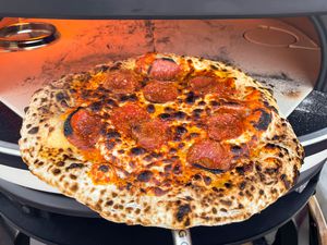 Pepperoni pizza coming out of the Dome oven