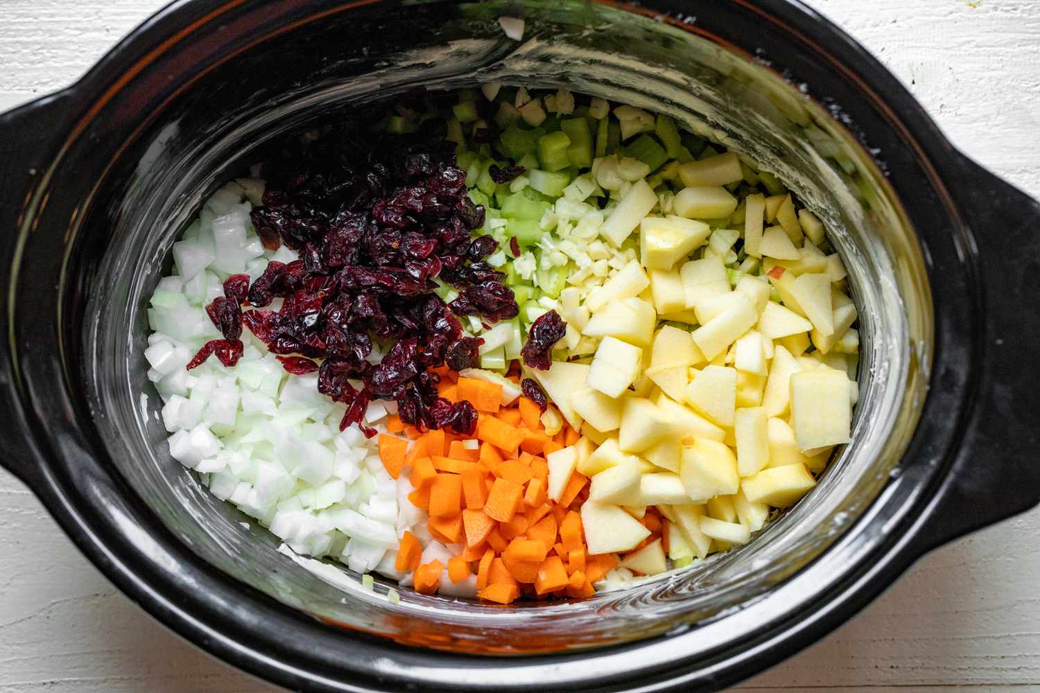 Apples, Carrots, Onions, Cranberries, and Celery in Slow Cooker for Crockpot Stuffing Recipe