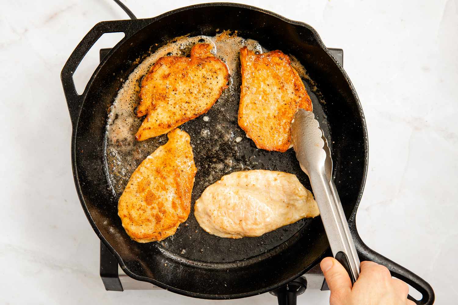 chicken flipped in the cast iron skillet for chicken marsala recipe