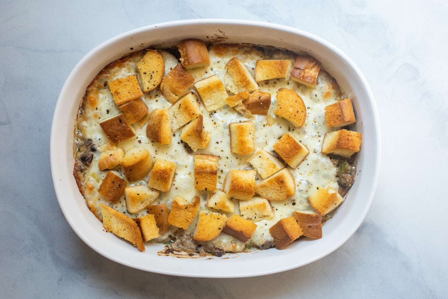 Baked Philly cheesesteak casserole in dish.