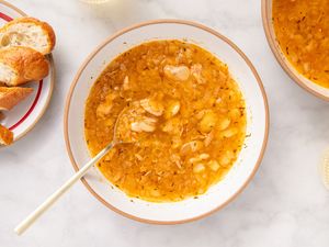 15-Minute Tuna and Butter Bean Stew in a bowl with spoon, bread on the side