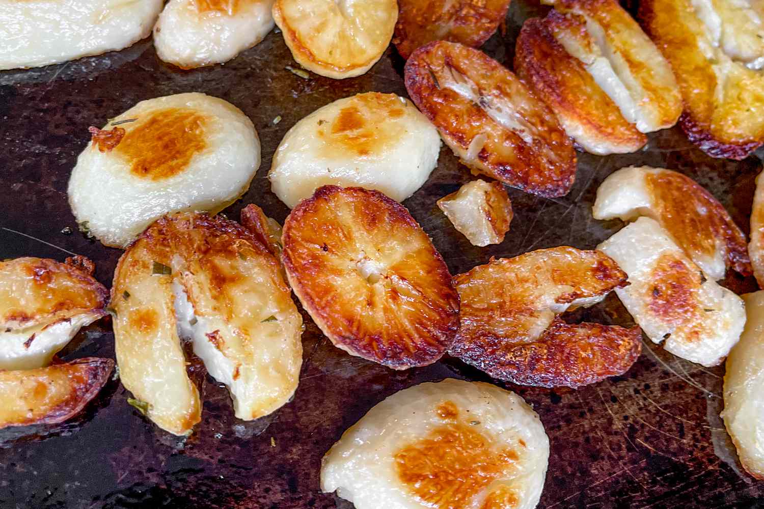 Well-browned roasted potatoes on a baking sheet