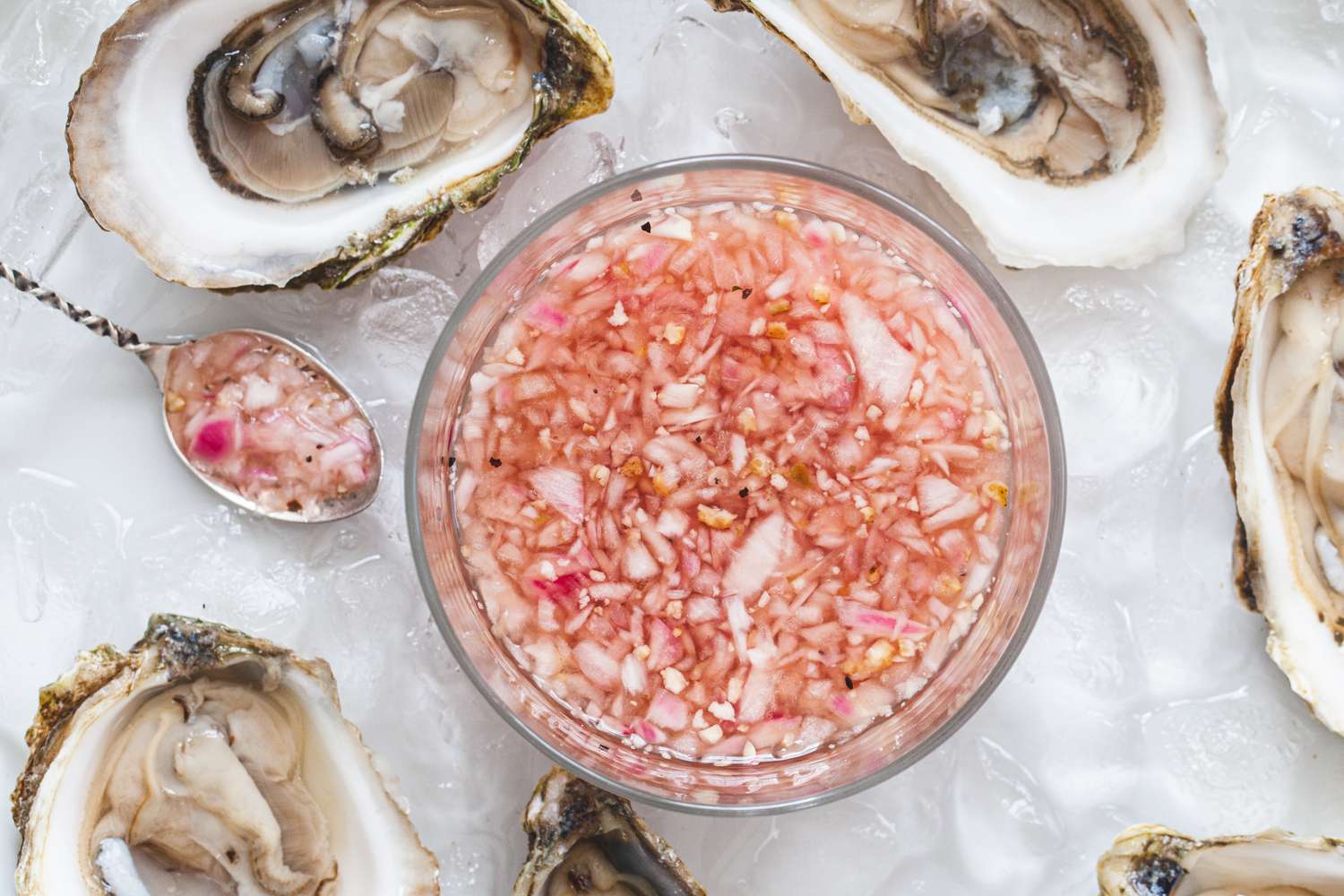 Overhead view of oyster sauce surrounded by oysters.