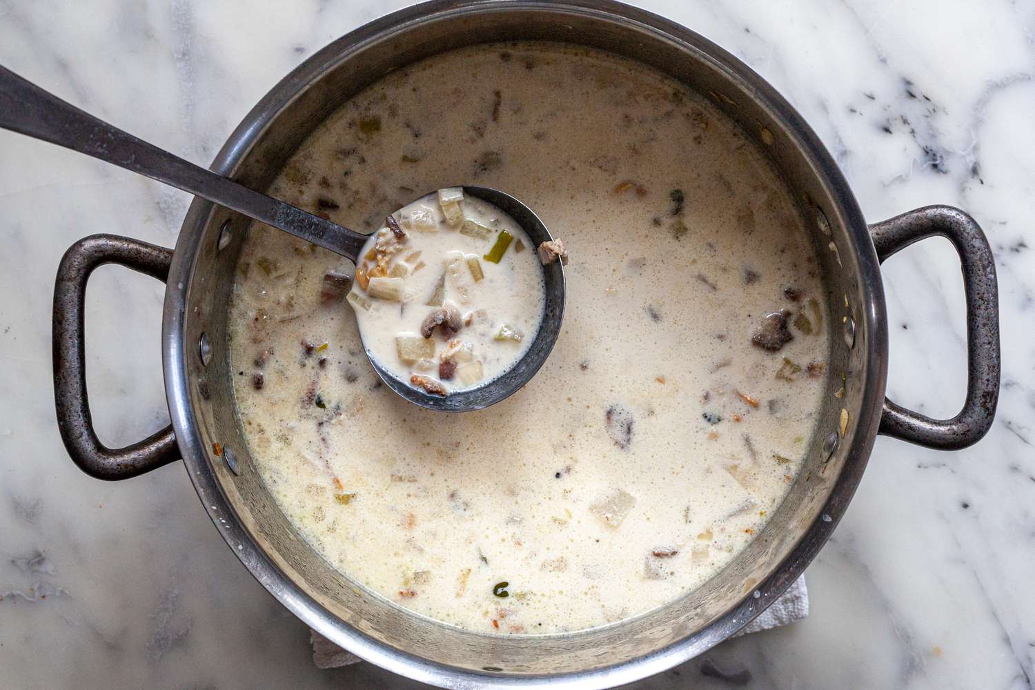 Pot of Classic New England Chowder with Some in a Ladle 