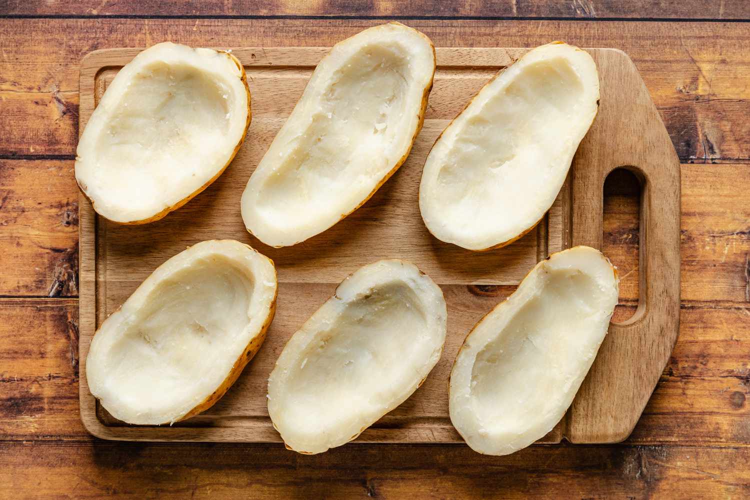 baked potatoes cut in half and the potato middles scooped out for cheeseburger stuffed baked potatoes recipe