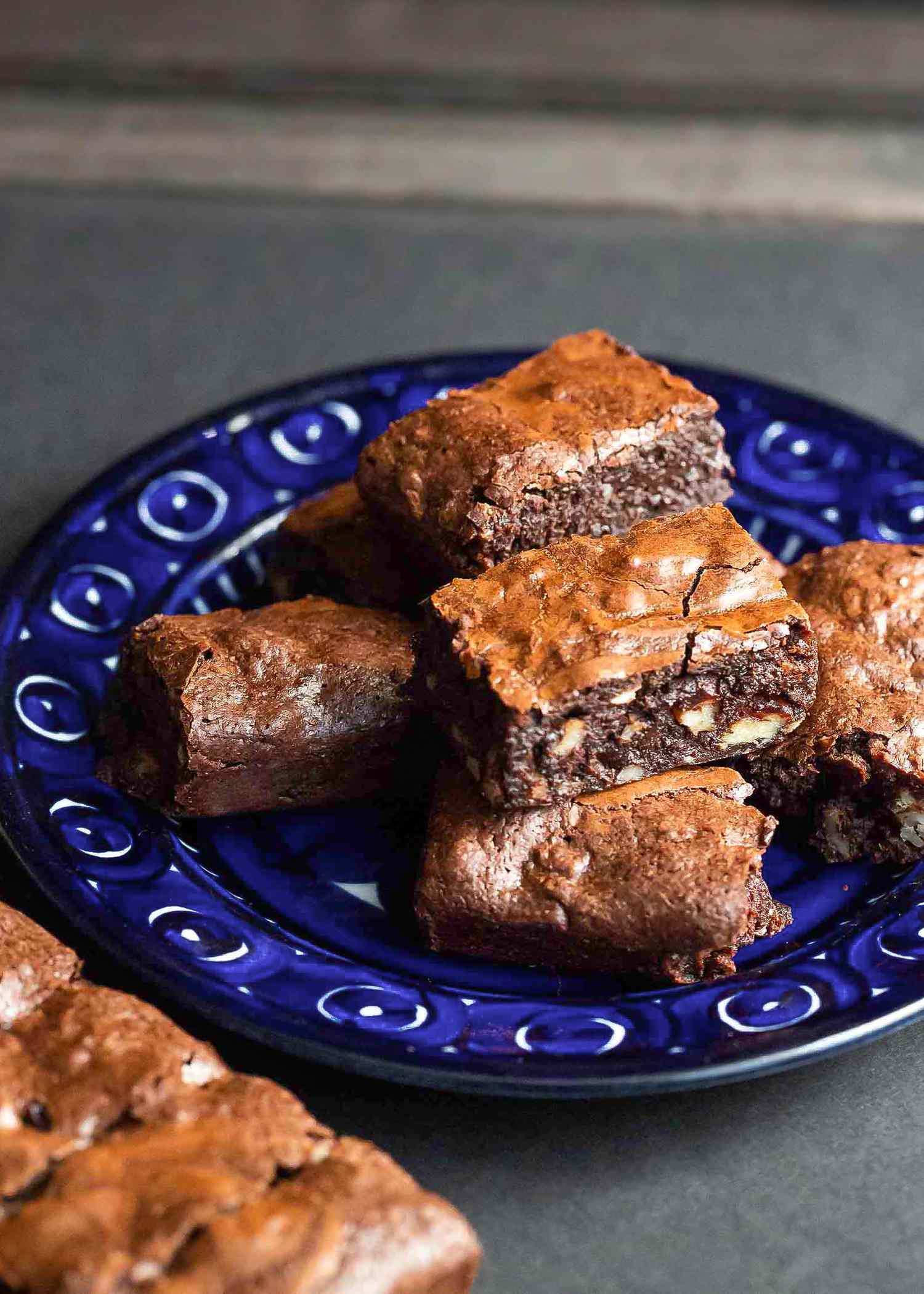 Brownies stacked on a plate.