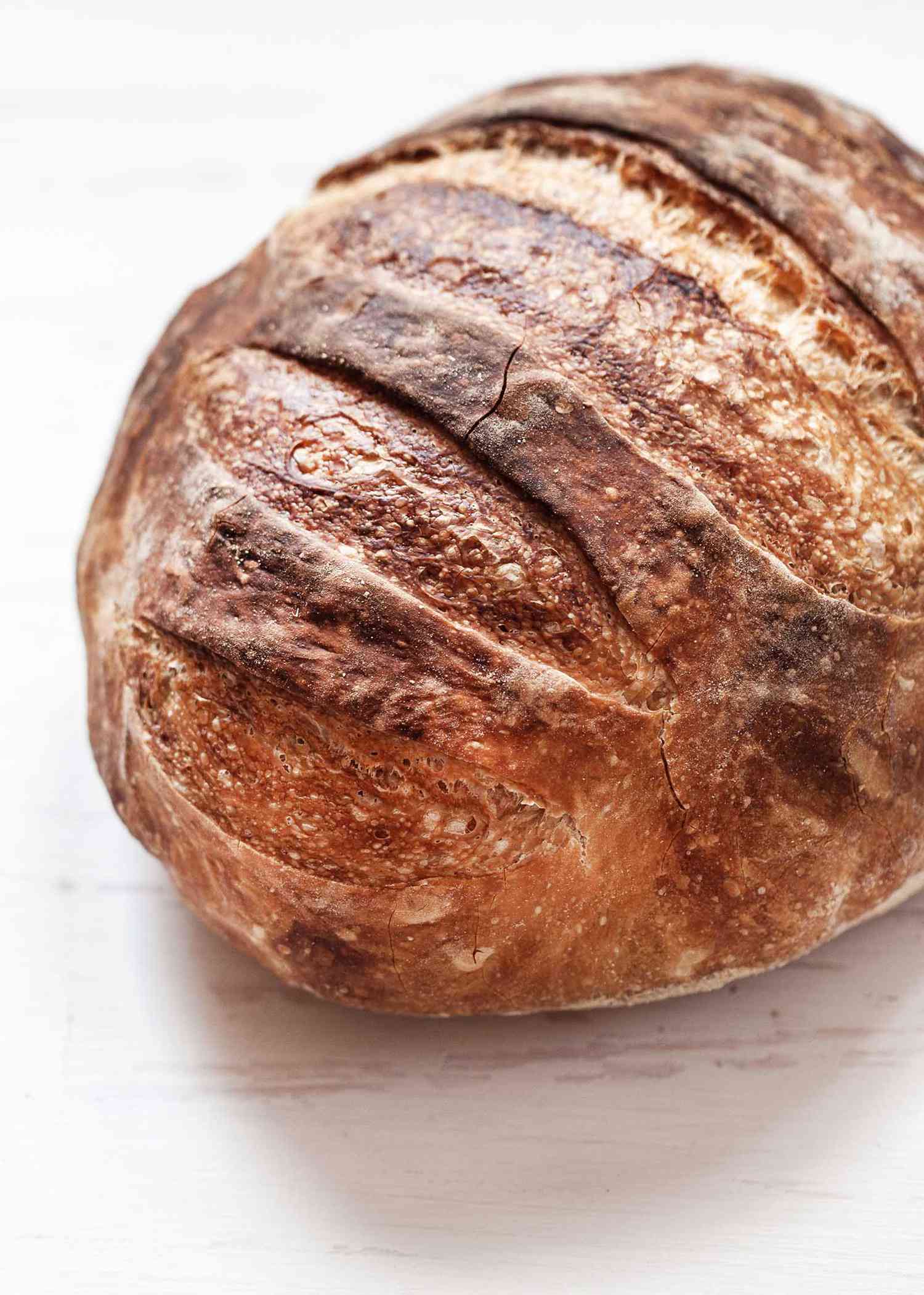 Overhead view of an easy no knead bread with a crispy crust that is dark brown.