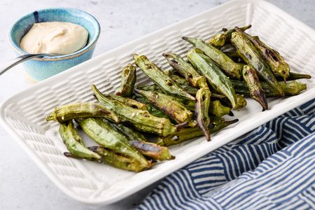 Platter of Grilled Okra Next to a Small Bowl of Sauce 