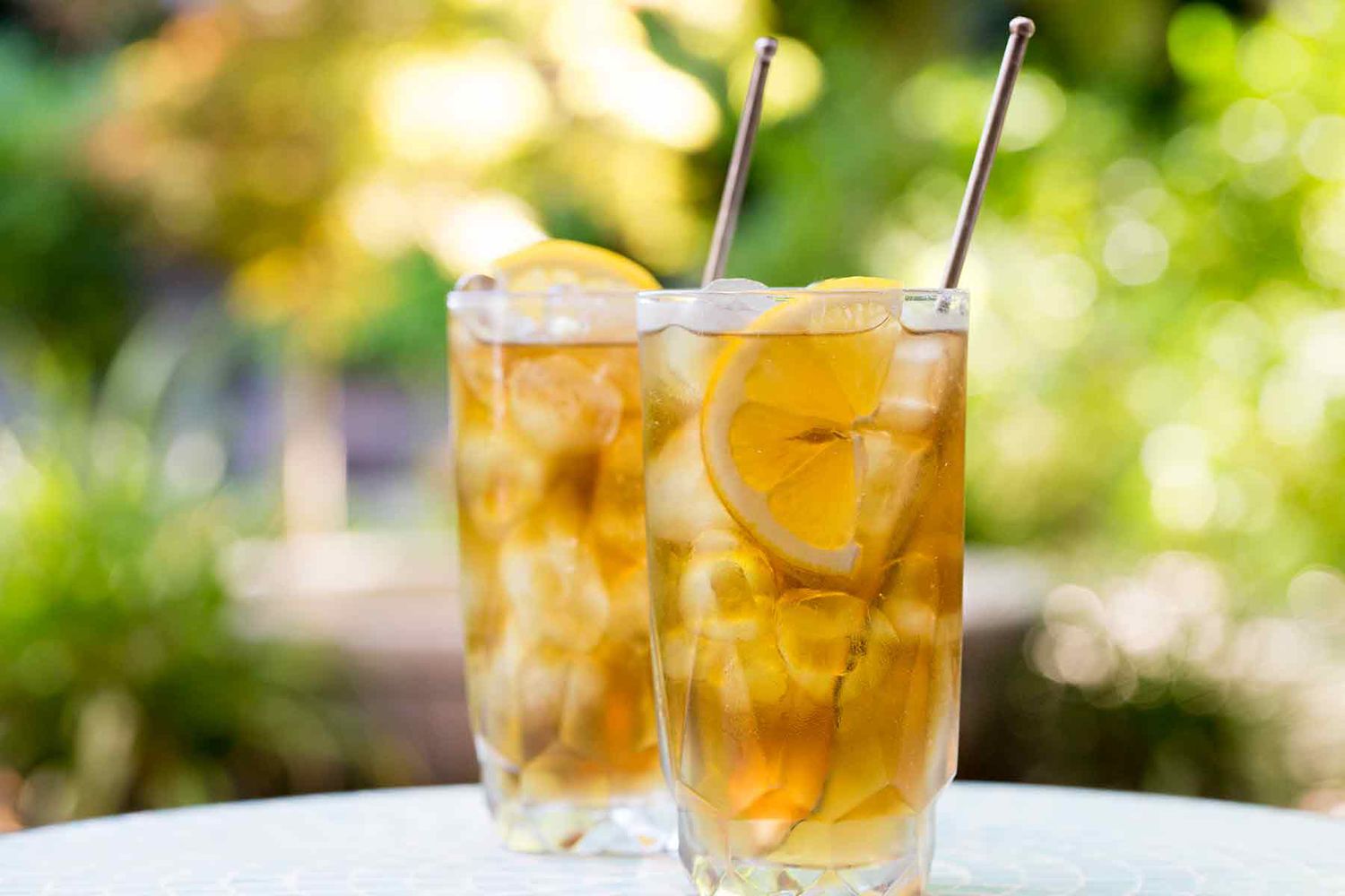 Two glasses of long island ice deal on a patio table outdoors